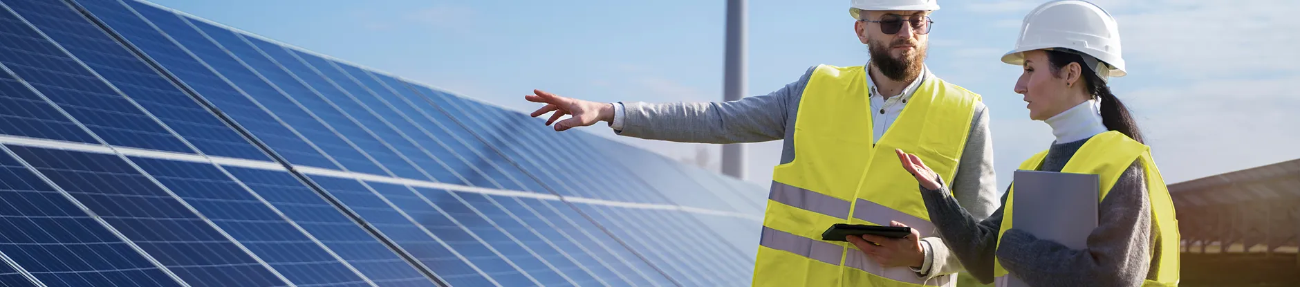 Solar engineers discussing a project on site